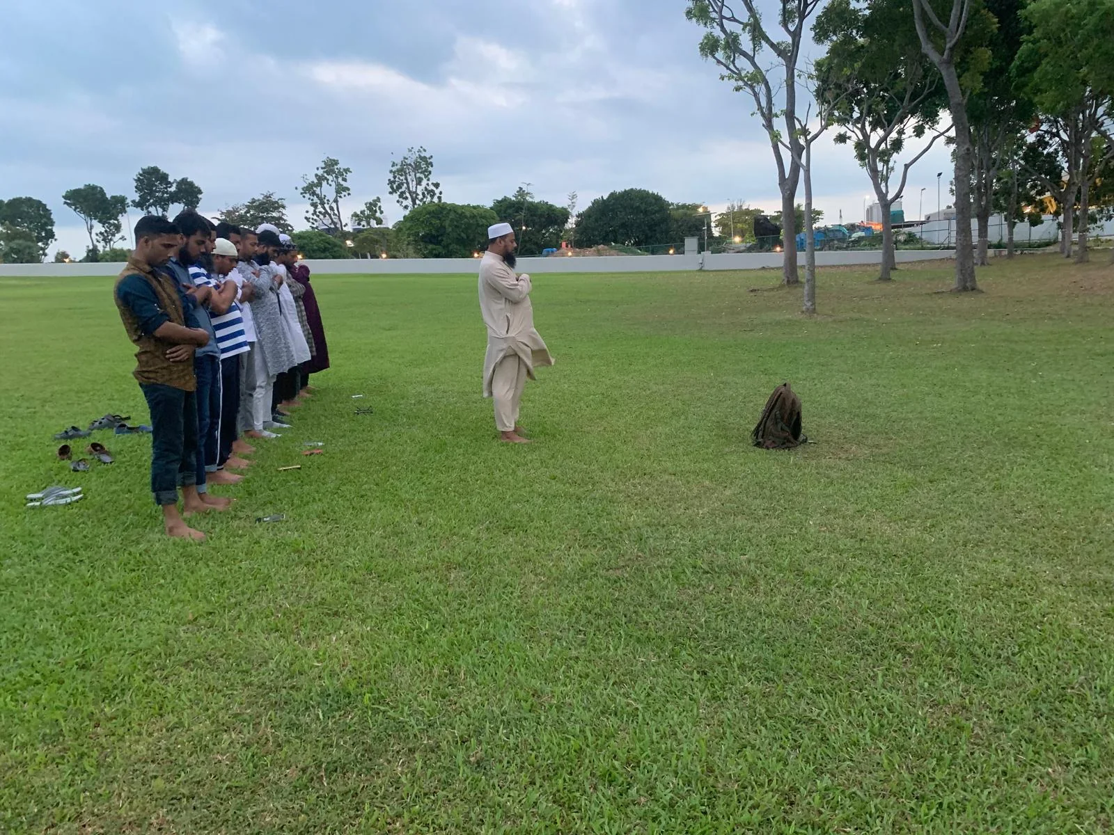 Volunteers praying together outdoors